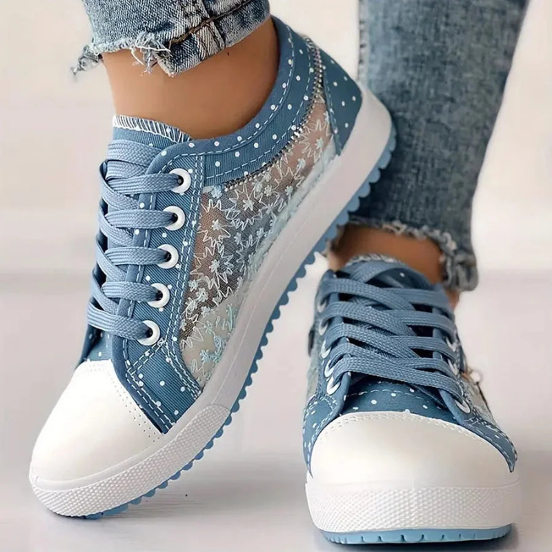 Woman standing in lightweight everyday sneakers against a plain background.