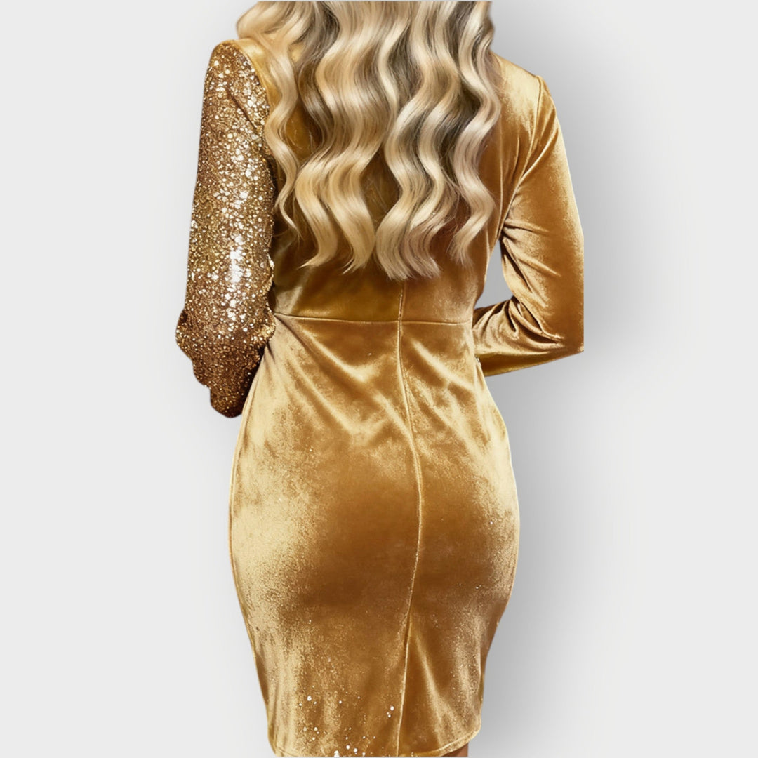 Fashion-forward party dress with angled hemline shown on a woman against a plain background.