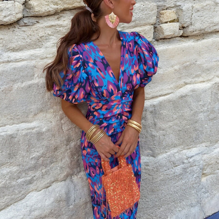 Colourful feminine dress featuring artistic detailing, lightweight fabric, and graceful movement.