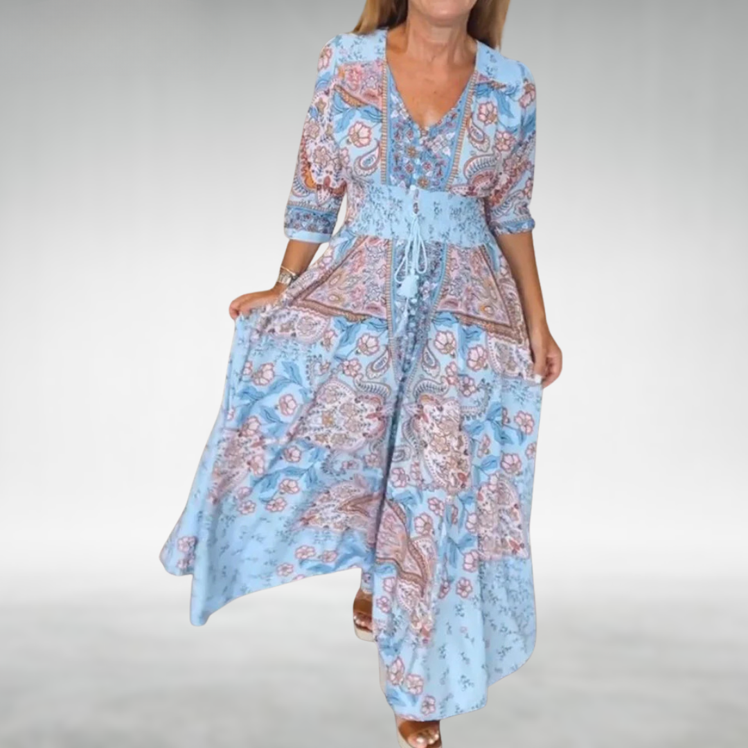 Long casual bohemian dress with flowing fabric on plain background.