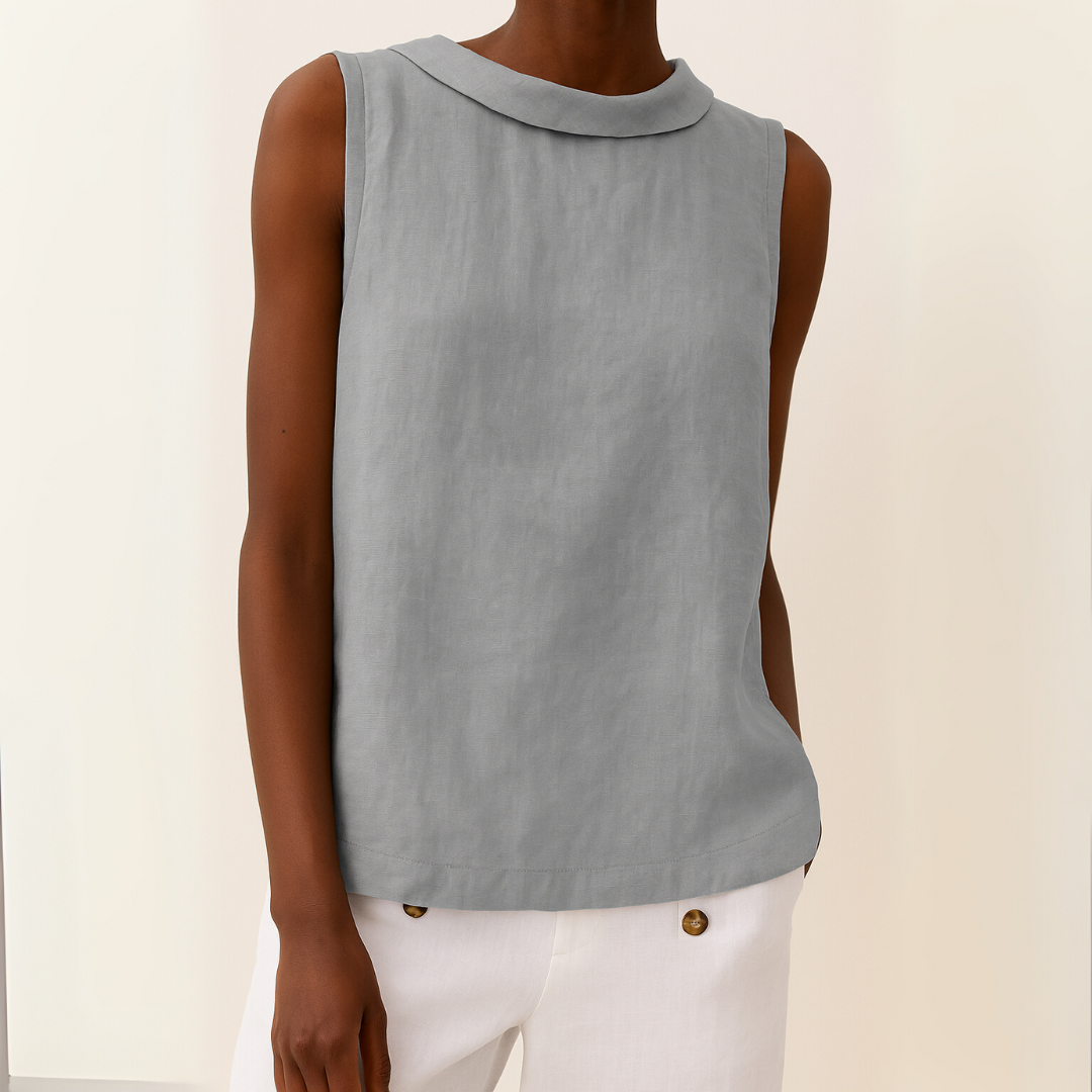 Sleeveless women’s draped roll collar top shown on a person against a plain background.