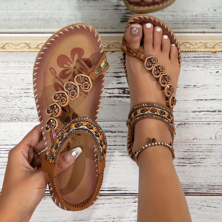 Woman feet wearing boho beach sandals on a clean background