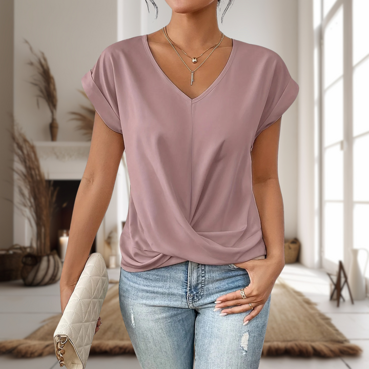 Soft feminine neckline tee worn by a model on a plain background.
