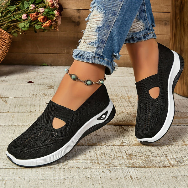 Woman modeling easy-wear shoes with a minimal everyday style.