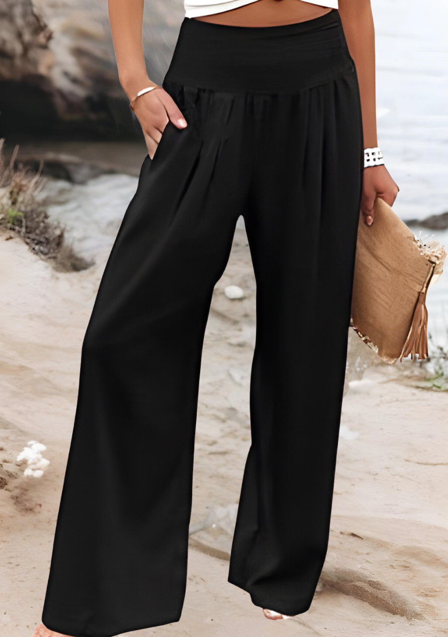 Lightweight women’s beach pants with soft drape on a beige background.