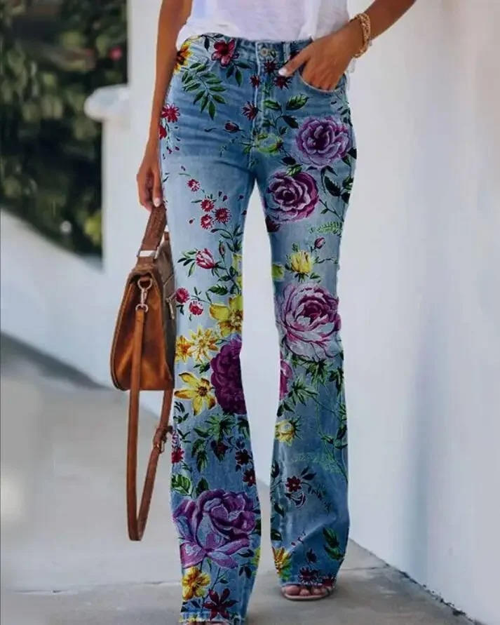 Colorful floral straight jeans on a plain studio backdrop.