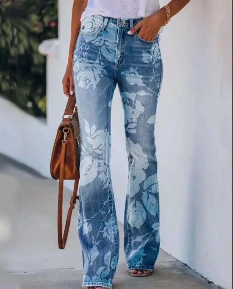 Retro flower print denim jeans on a plain background.