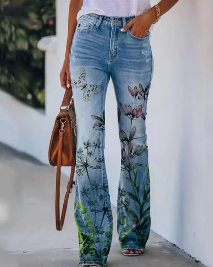 Straight leg printed denim pants on a clean plain backdrop.
