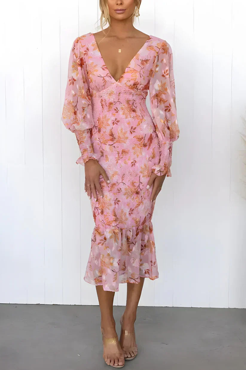 Female model in a colorful flower dress on a clean background.