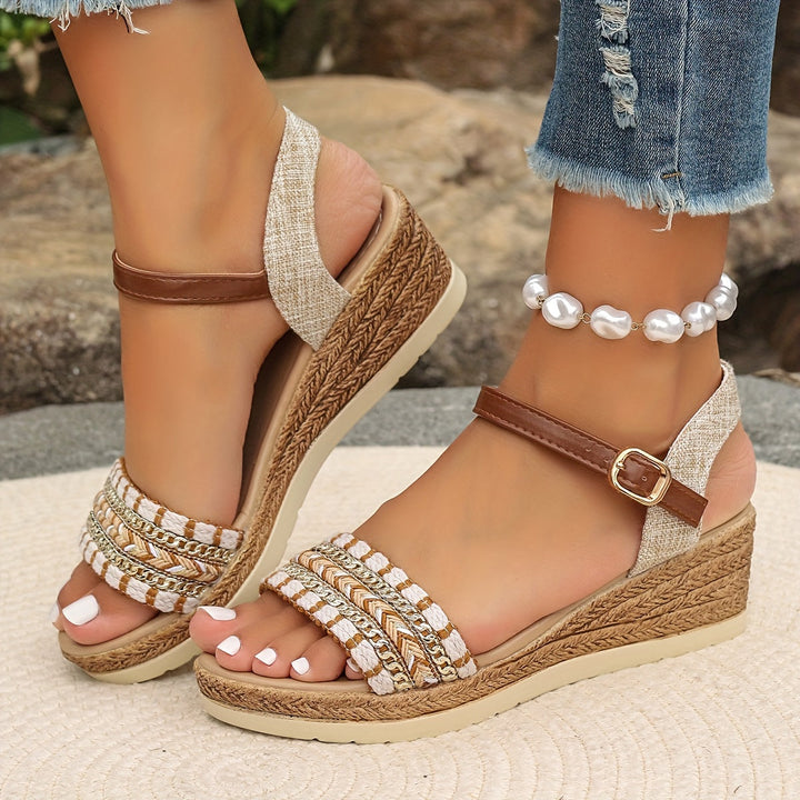 Model showing side view of woven wedge sandals on a plain background.