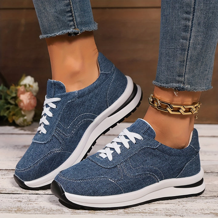 Women’s denim-inspired sneakers on a plain background with a casual everyday look.