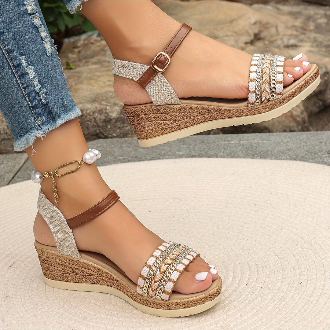 Female model wearing boho woven wedge sandals against a plain background.