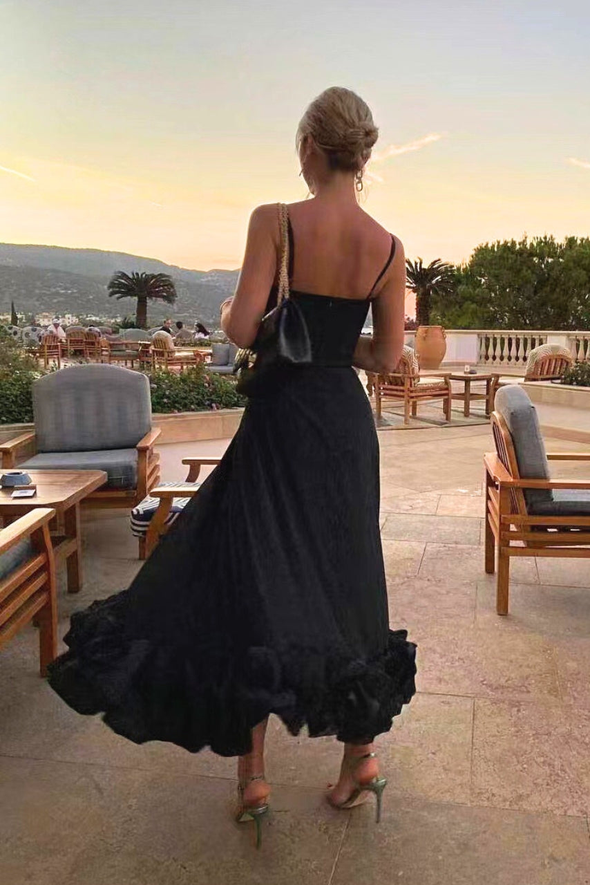Model showcasing a soft flowing dress with a plain backdrop, back view