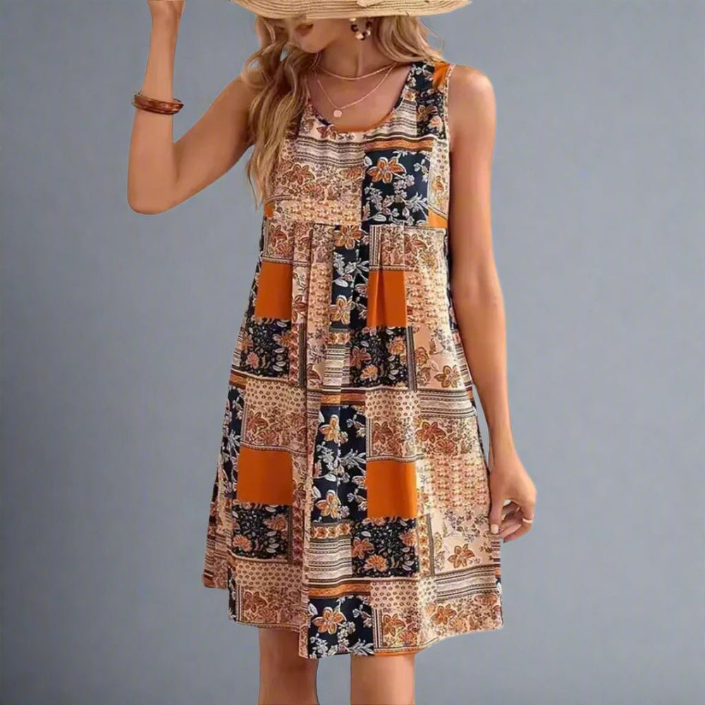 Sleeveless printed mini dress shown on plain background for summer styling.
