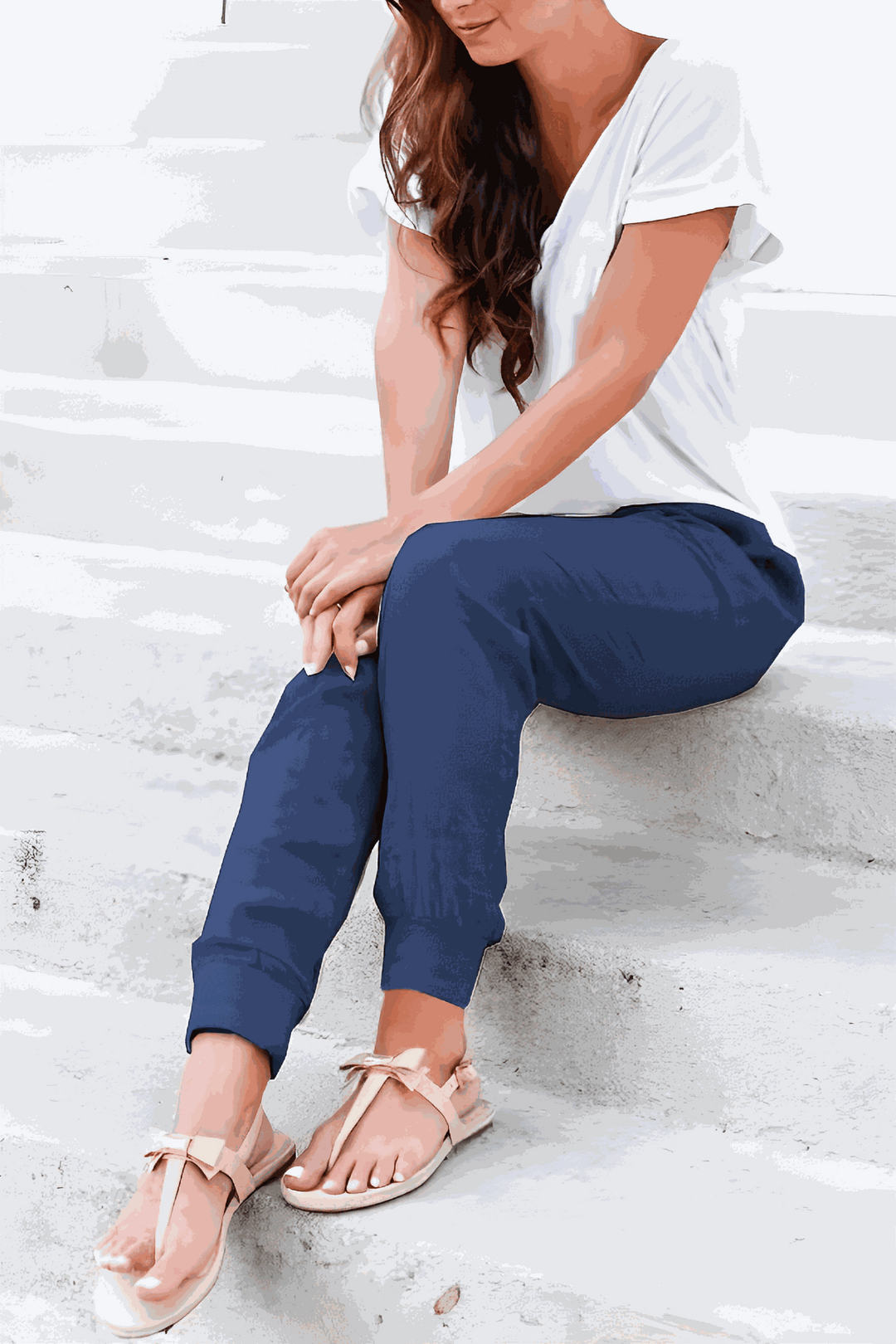 Woman wearing relaxed fit pants with ankle cuffs and side pockets