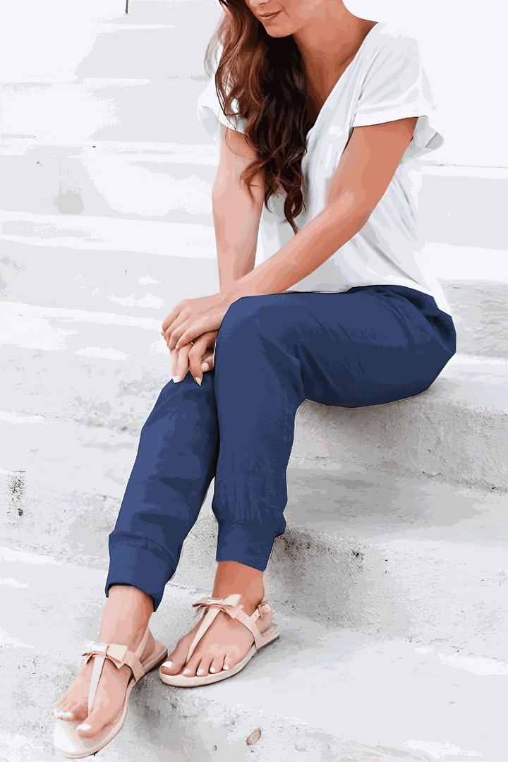 Woman wearing relaxed fit pants with ankle cuffs and side pockets