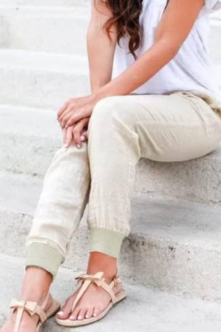 Casual ankle pants displayed on a plain background with relaxed tapered legs.