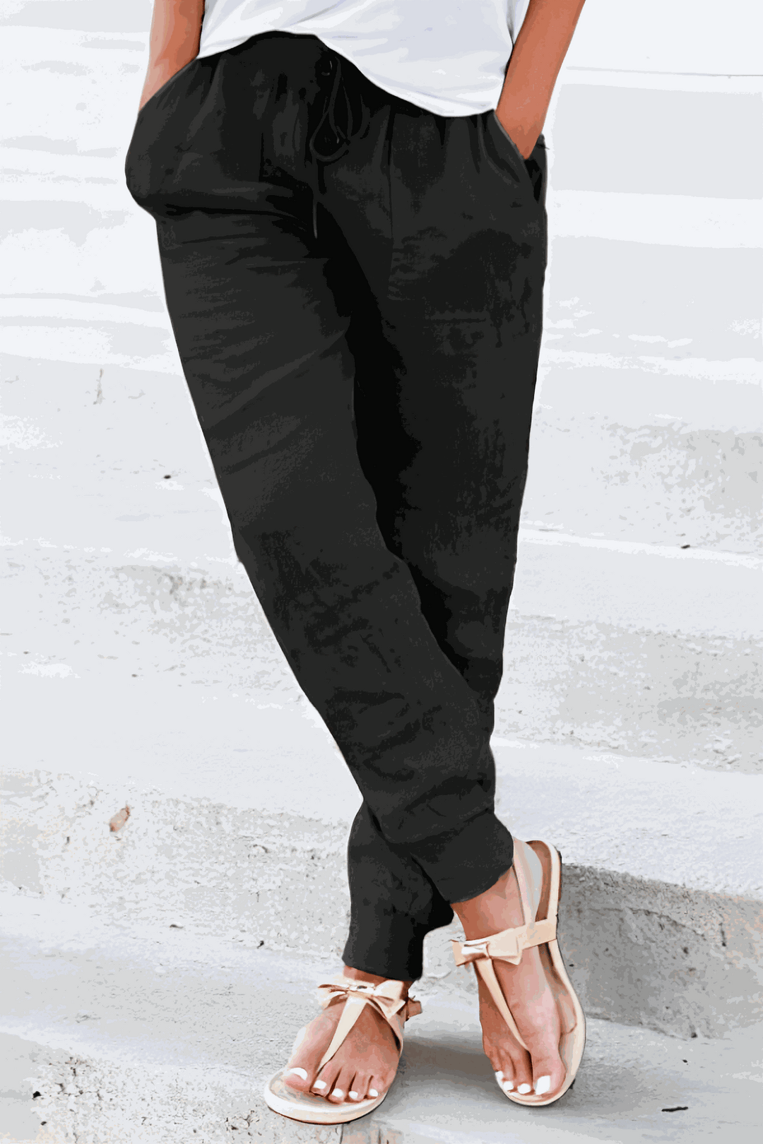 Woman in lightweight tapered pants with elastic waist on a clean background.