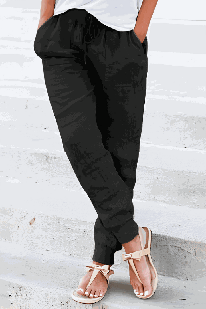 Woman in lightweight tapered pants with elastic waist on a clean background.