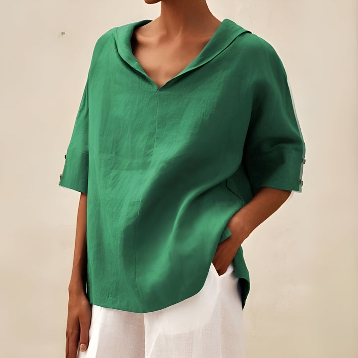 Soft breathable blouse presented on a plain background with comfortable sleeves and casual elegant appeal.
