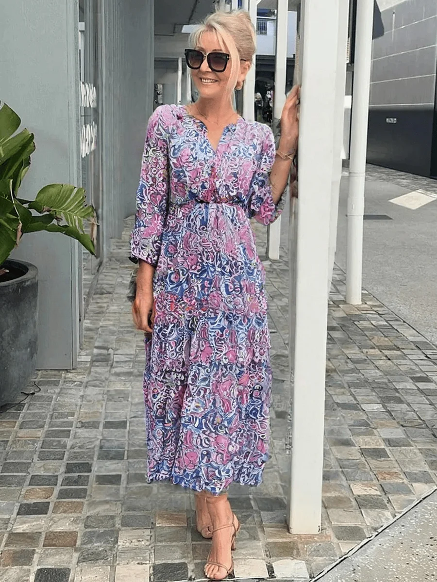 Sleeveless floral midi dress displayed on a outdoor background