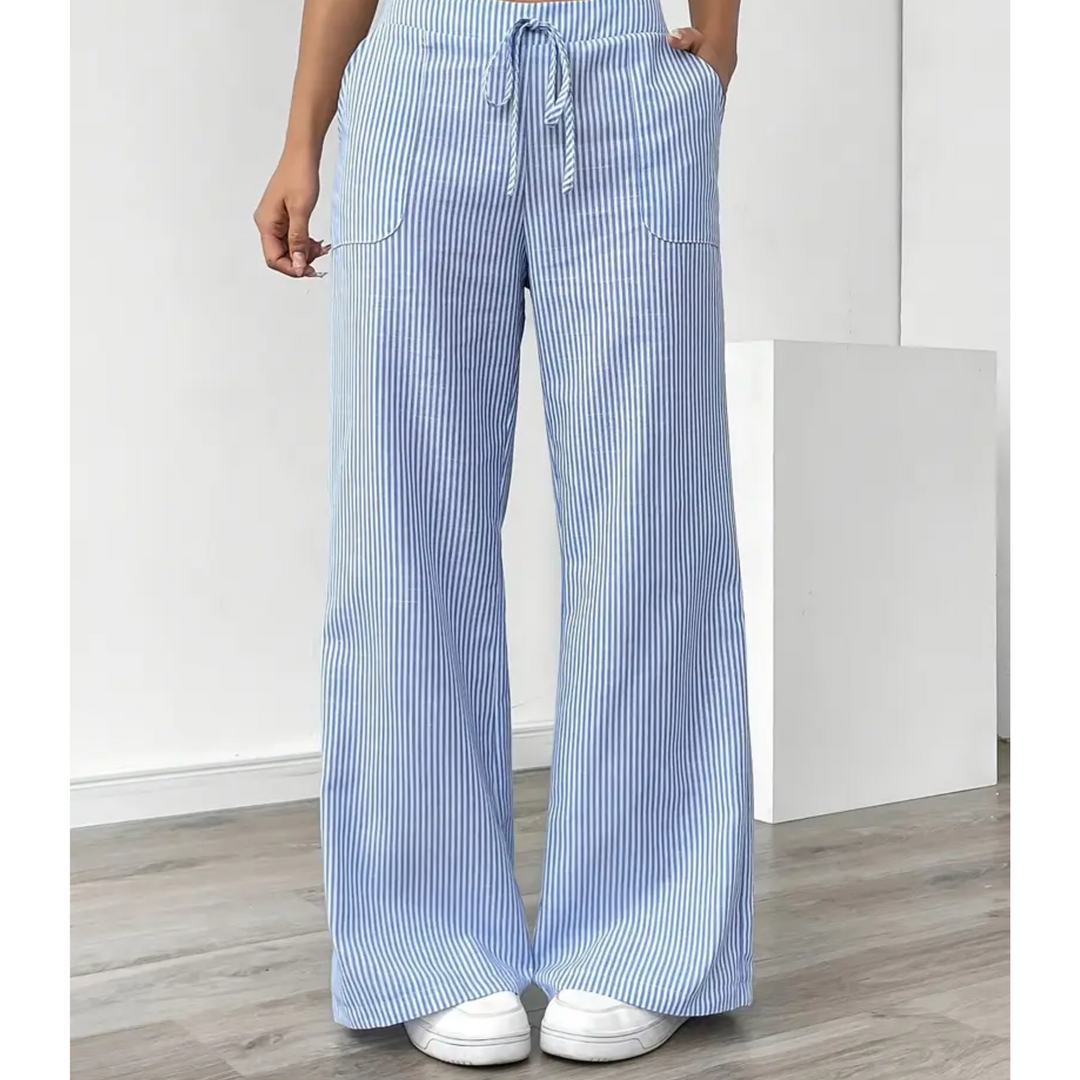 Women’s vertical stripe trousers with relaxed fit on a plain background.