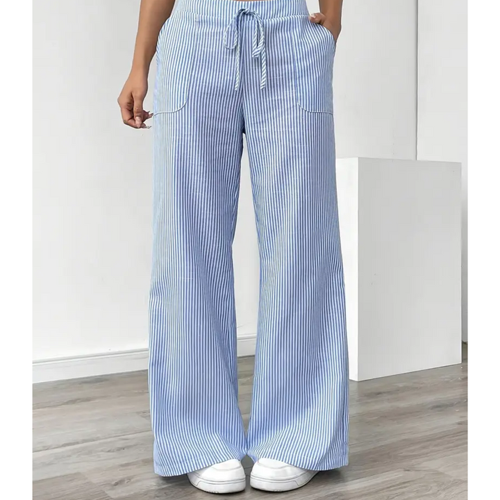 Women’s vertical stripe trousers with relaxed fit on a plain background.