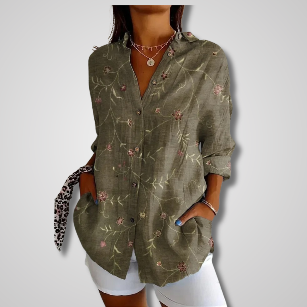 Elegant relaxed-fit women’s shirt w/ model on a plain background.