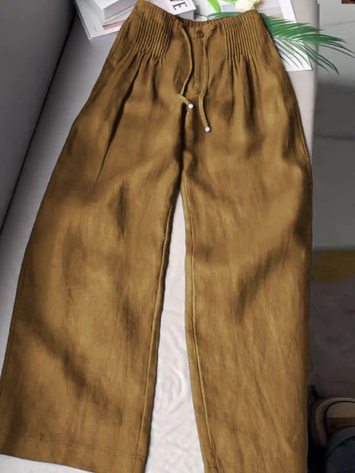 Wide-leg pants shown on a plain background with soft draping fabric.