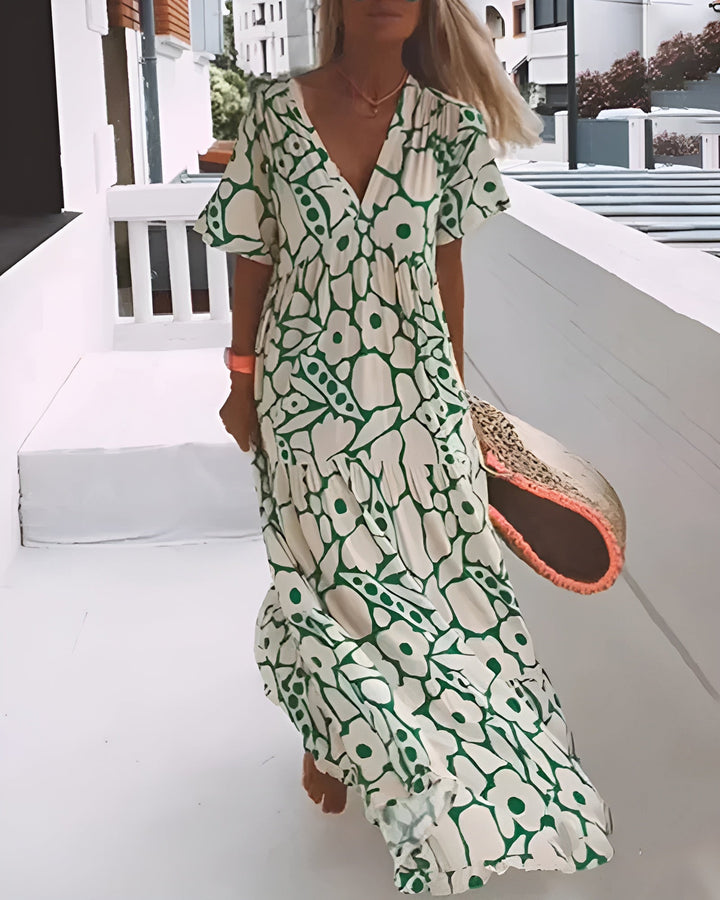 Woman wearing a flowing maxi dress while walking outdoors on a sunny day.