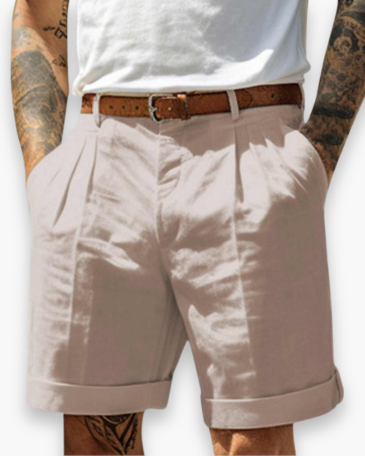 Model displaying classic summer shorts with structured pleat details on a plain background.