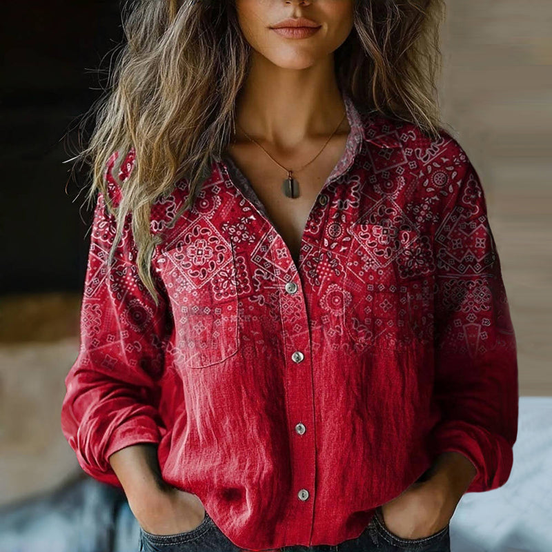 Relaxed bohemian blouse with vintage-inspired prints on a plain background.