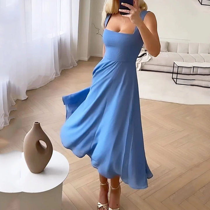Female model side angle showcasing square neckline dress in indoor set-up