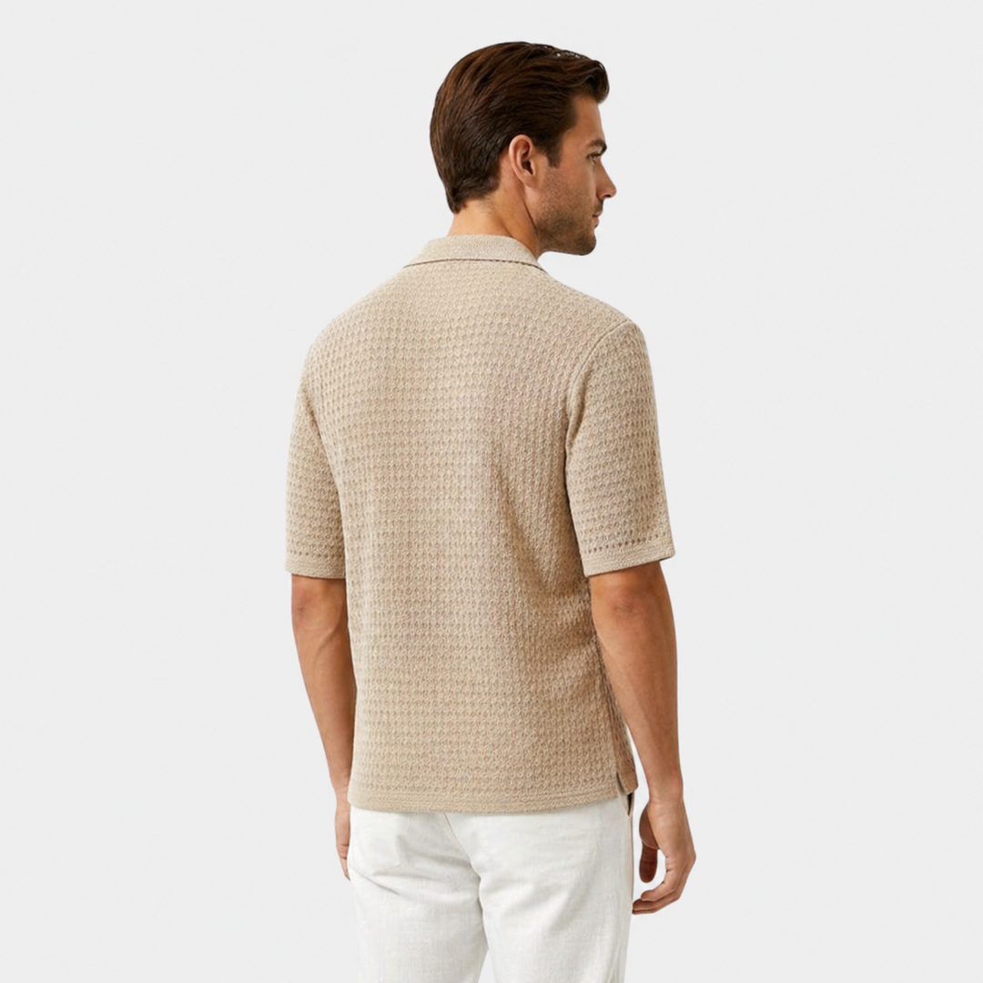  Male model in a refined short sleeve knit shirt on a plain background.