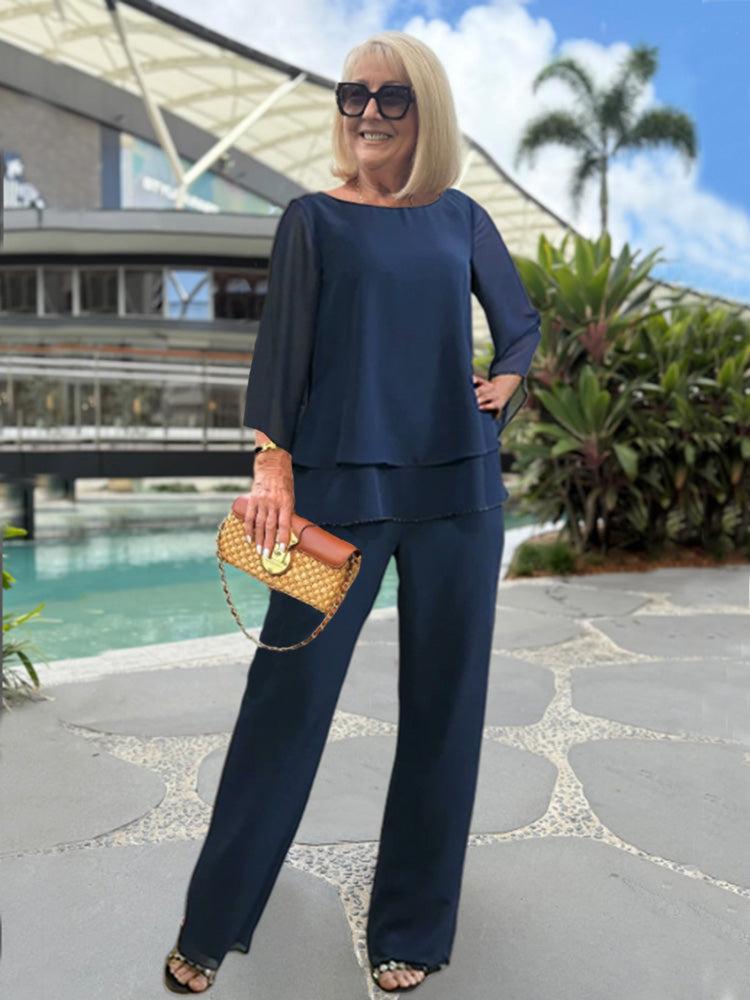 Female model wearing a women’s two-piece trouser set on a plain background.