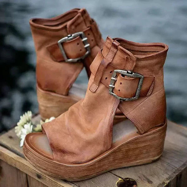 Adjustable buckle wedge sandals with cushioned footbed on a plain background.