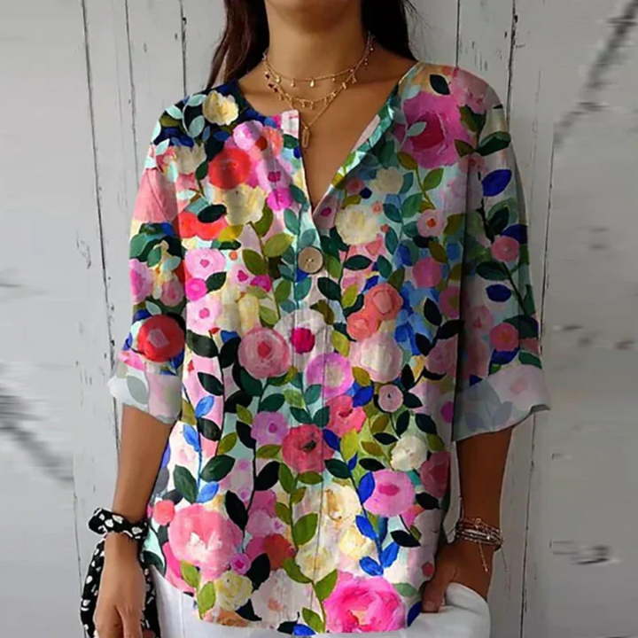 Casual floral blouse with model on a plain background and polished front detail.