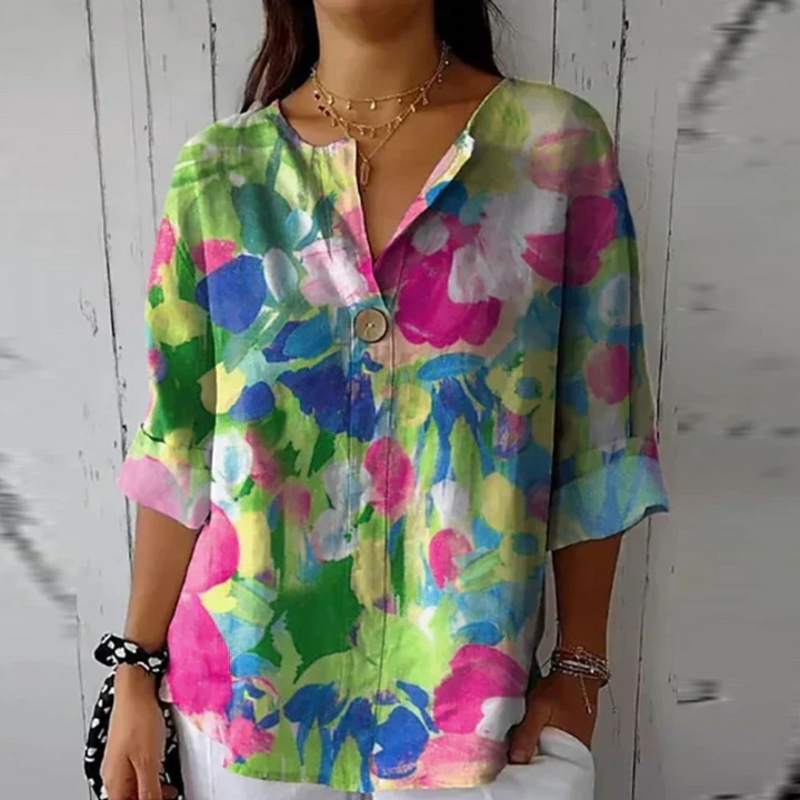 Button-front floral blouse with model on a clean background and soft print.