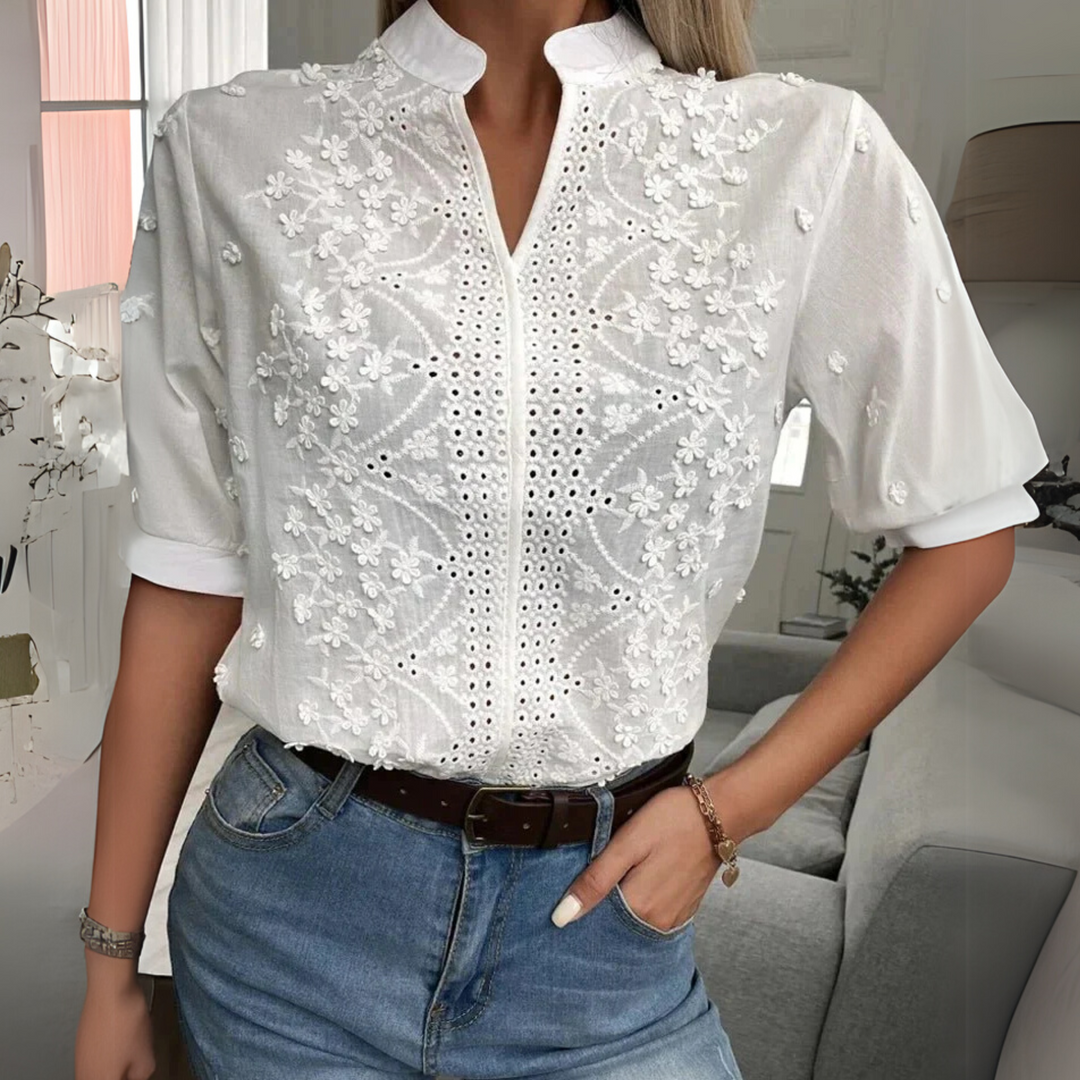 Elegant women’s blouse shown on a wearer against a plain background.