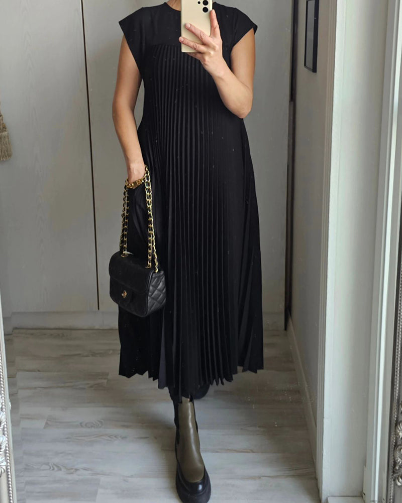 Airy maxi dress with flowing fabric displayed in a minimal studio setting.