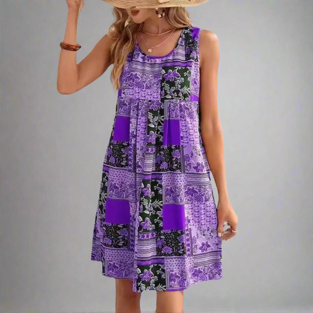 Summer boho dress with scoop neck, empire waist, and relaxed skirt.