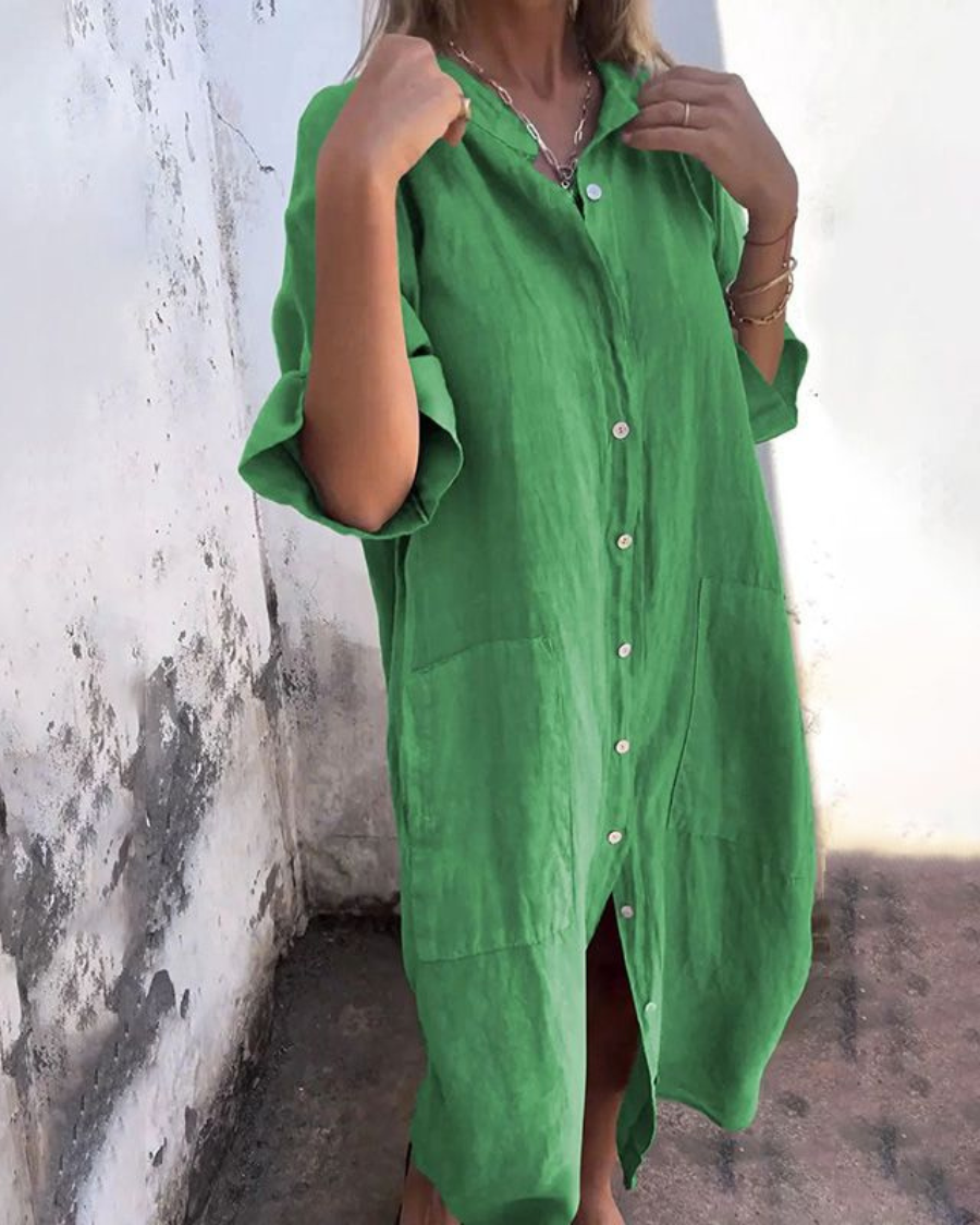 Tie waist shirt dress presented with a model on a plain background.