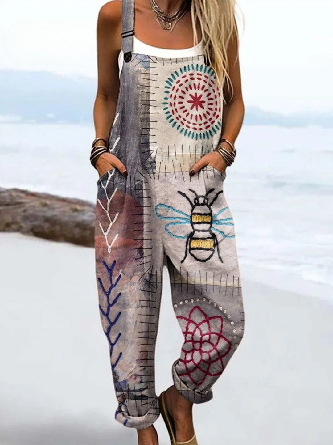 Bee print women’s jumpsuit on a plain background with a relaxed flowy fit.
