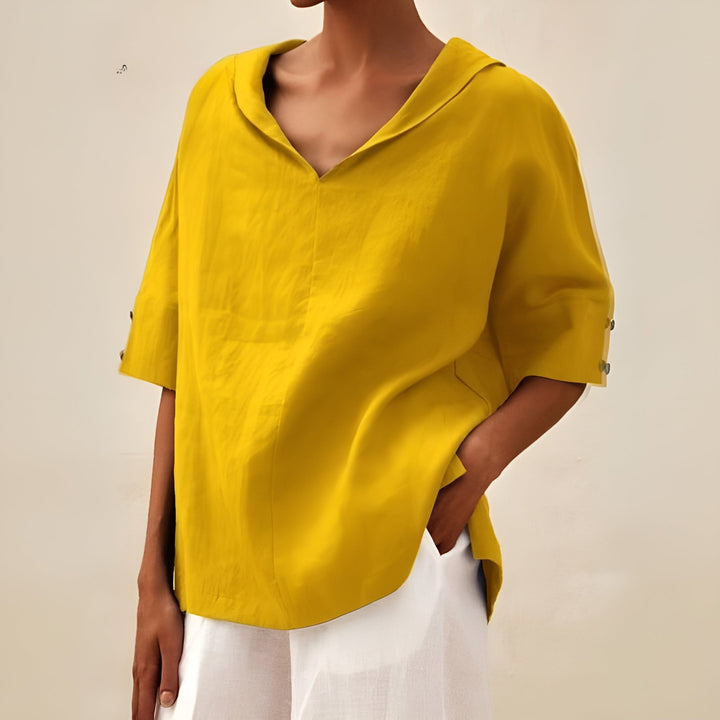 Women’s everyday blouse on a clean background featuring a relaxed silhouette and smooth draped design.