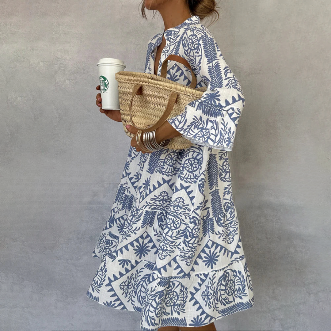 Blue and white boho print swing dress on a plain background.