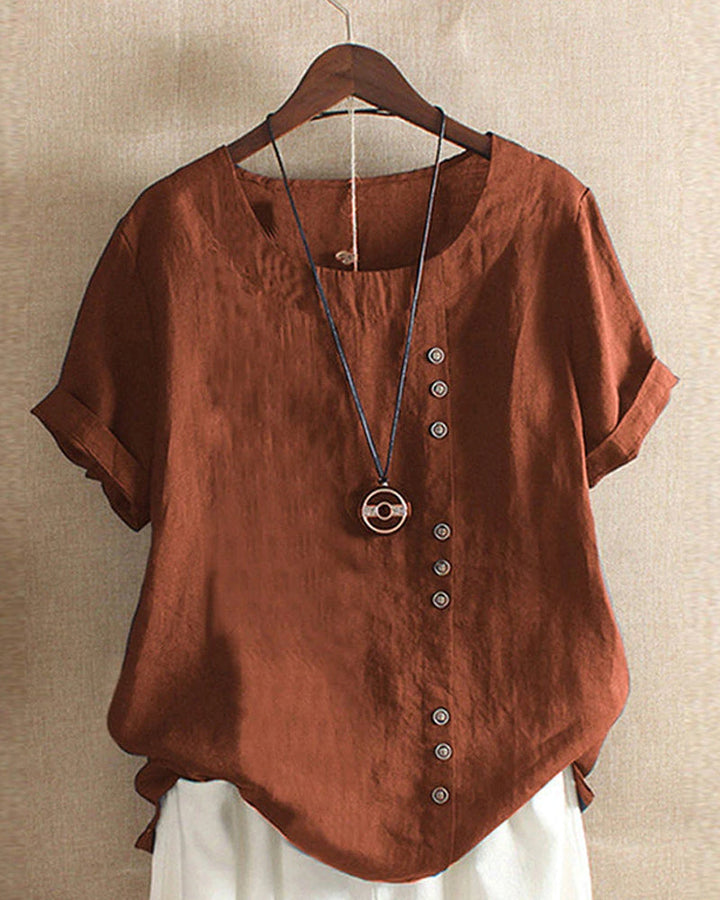 Breathable linen blouse displayed neatly on plain studio background.