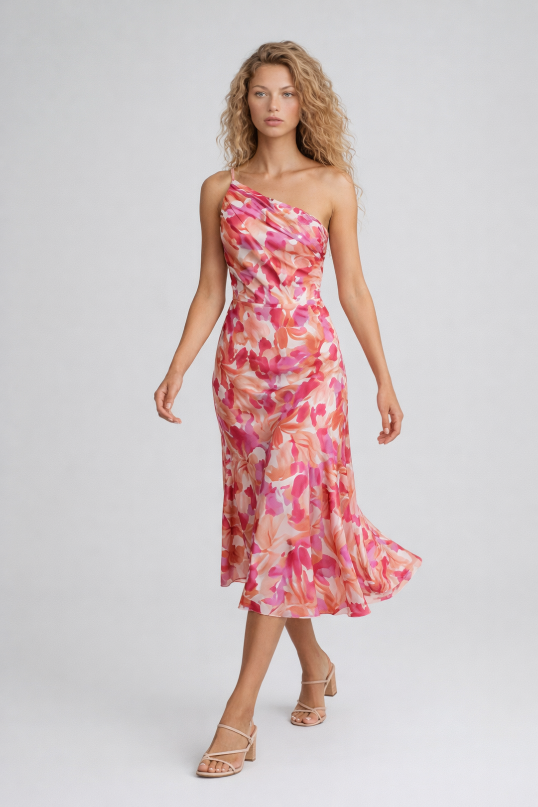 Female model in a floral midi dress with a draped bodice on a plain background.