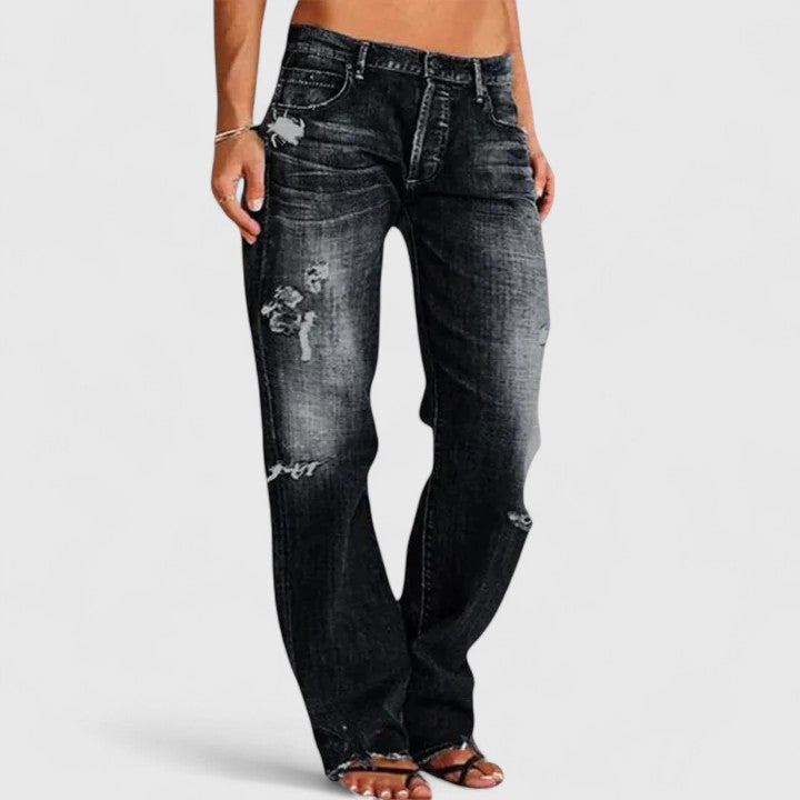  Woman showcasing wide-leg flare denim with vintage-inspired styling on a plain background.