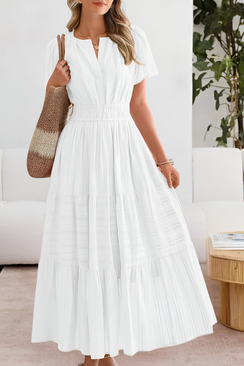 Relaxed fit summer dress with elegant flow shown on a plain background.