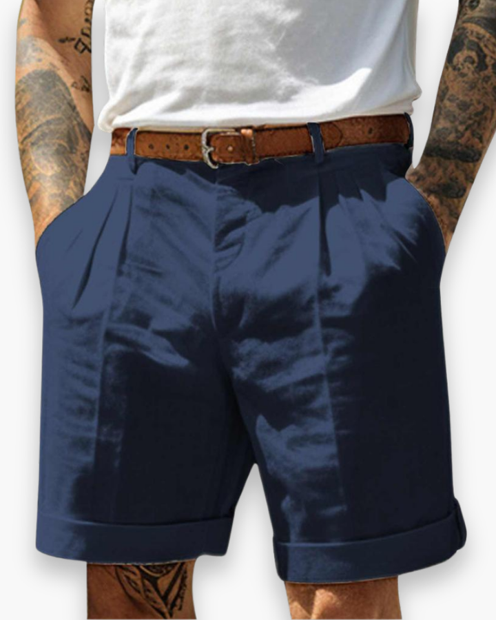 Man wearing versatile chino shorts styled for warm-weather outfits on a plain background.